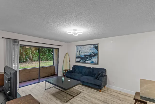 a living room with furniture and a floor to ceiling window