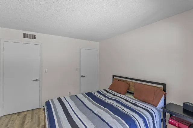 a bedroom with a bed and a lamp