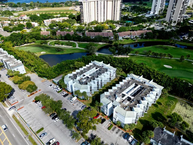 an aerial view of a house with a garden and lake view
