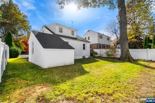 a front view of house with yard and trees