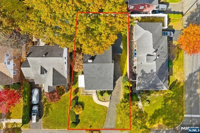 aerial view of residential houses with outdoor space and parking