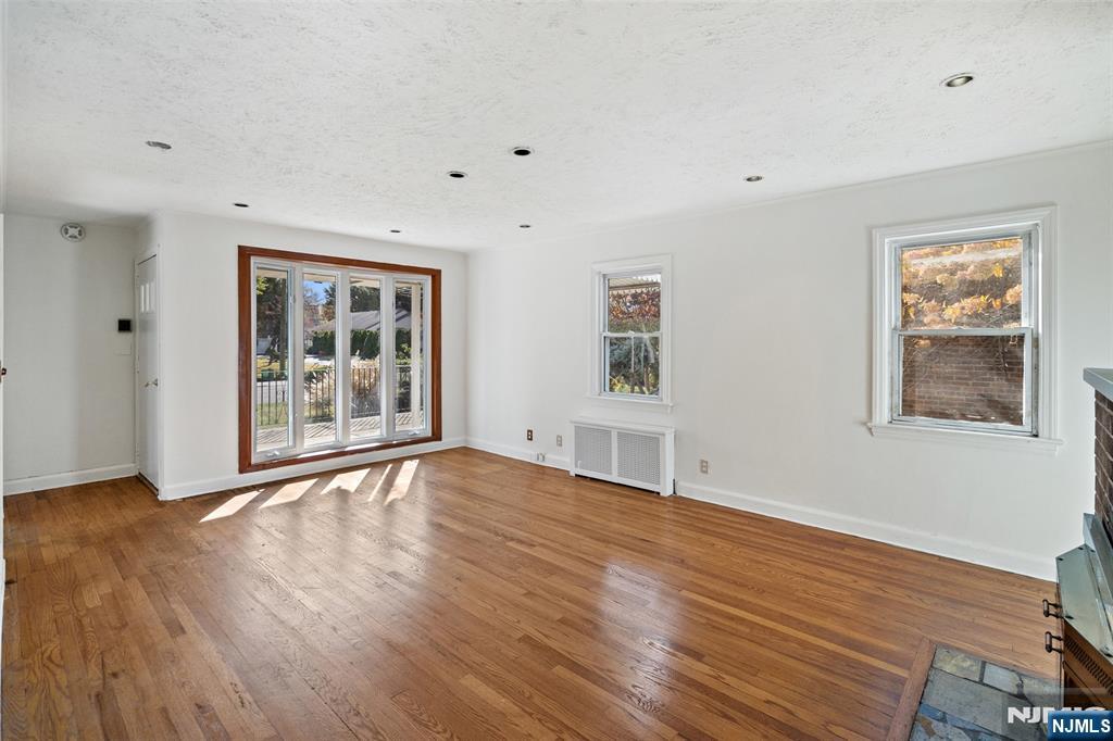 811 Summit Avenue Hackensack, NJ 07601 - Photo 4 of 26 a view of an empty room with window and wooden floor