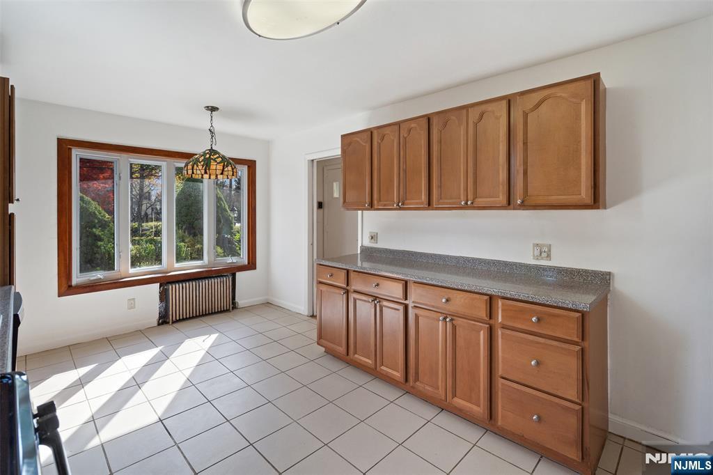 811 Summit Avenue Hackensack, NJ 07601 - Photo 8 of 26 a kitchen with stainless steel appliances granite countertop a sink cabinets and a large window