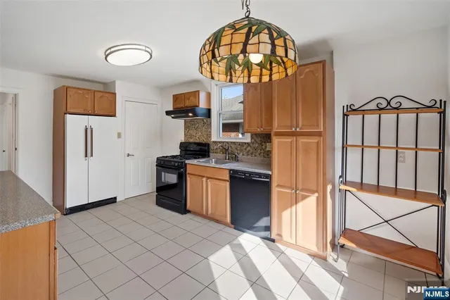 a kitchen with stainless steel appliances granite countertop a stove a refrigerator and a microwave