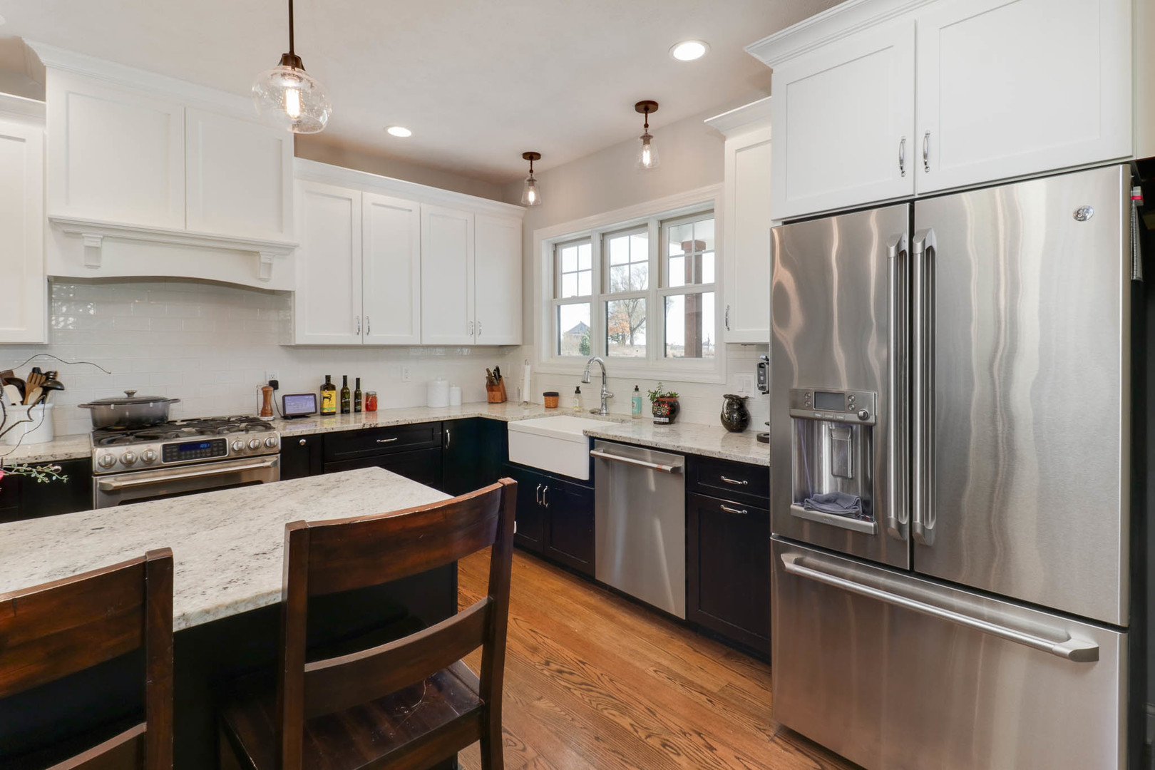 16658 North 200 East Road Danvers, IL 61732 - Photo 14 of 47 a kitchen with stainless steel appliances granite countertop a refrigerator a sink dishwasher a stove and white countertops with wooden floor
