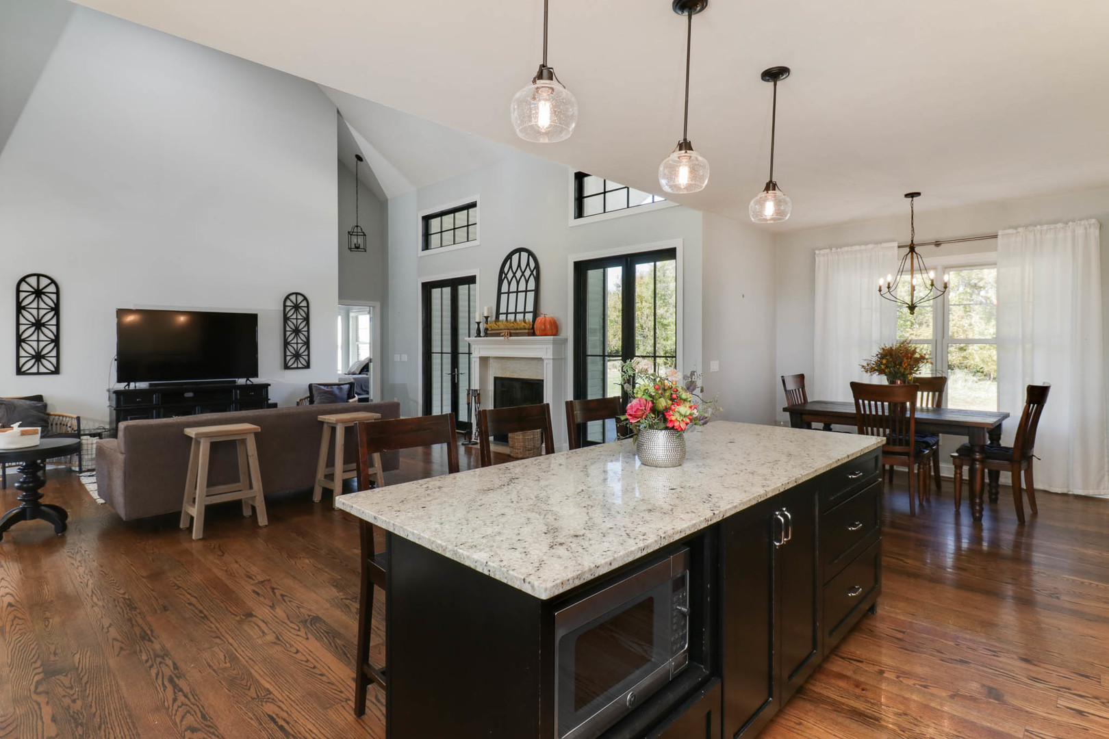 16658 North 200 East Road Danvers, IL 61732 - Photo 16 of 47 a kitchen with granite countertop a table chairs sink and wooden floor