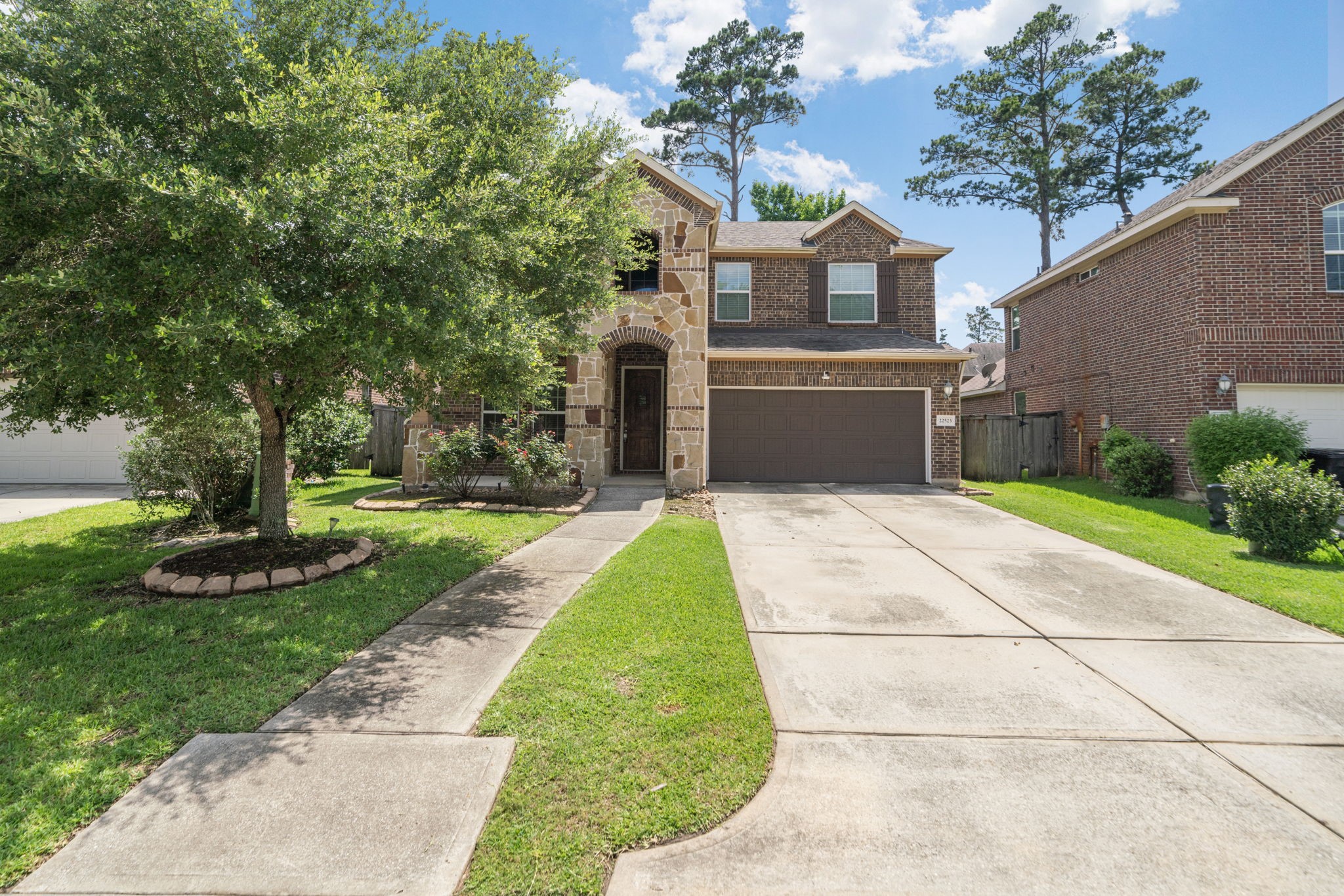 22523 Birch Ridge Meadow Drive Spring, TX 77389 - Photo 36 of 39 a front view of a house with a yard and trees
