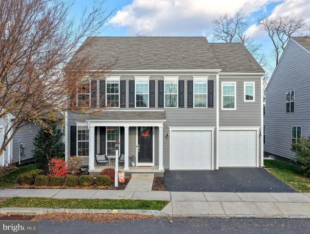 a front view of a house with garden and porch
