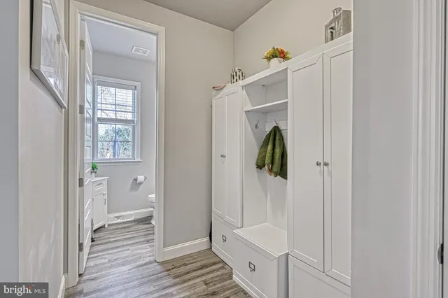 a view of a hallway with a livingroom and stairs
