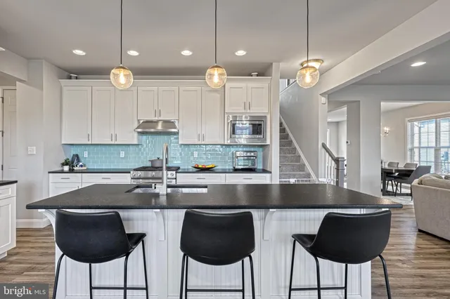 a kitchen with granite countertop a counter space cabinets and stainless steel appliances
