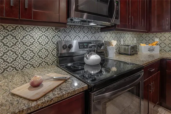 a kitchen with a sink refrigerator and cabinets