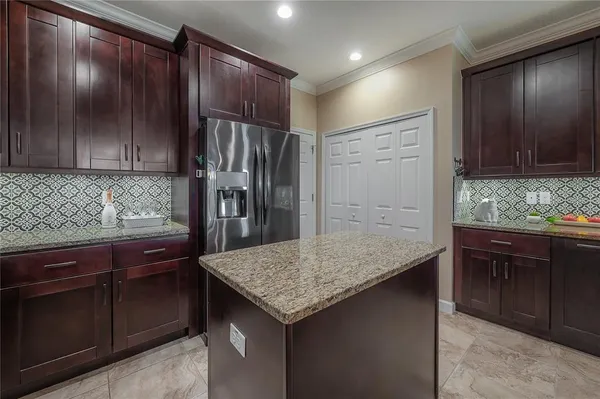 a kitchen with granite countertop cabinets and wooden floor