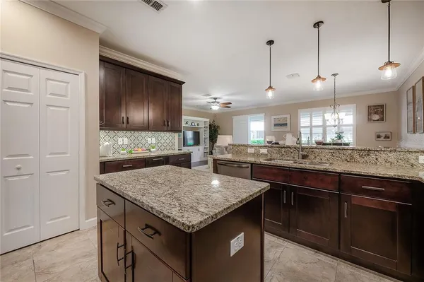 a kitchen with granite countertop wooden cabinets and granite counter top
