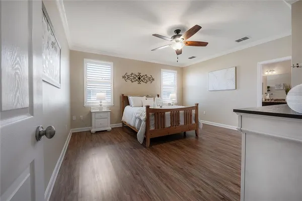 a large white bed sitting in a bedroom next to a window