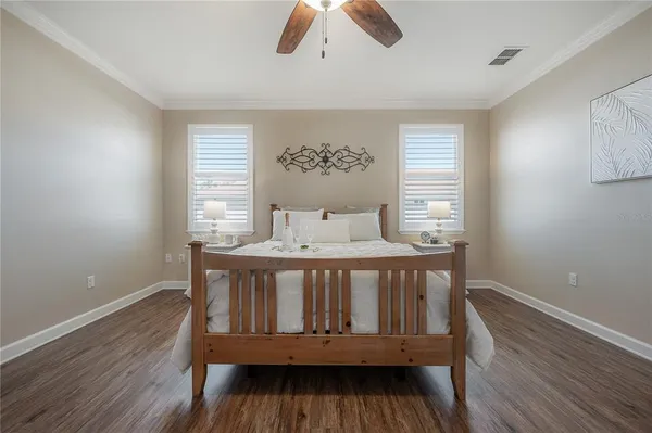a bedroom with a bed and a chandelier