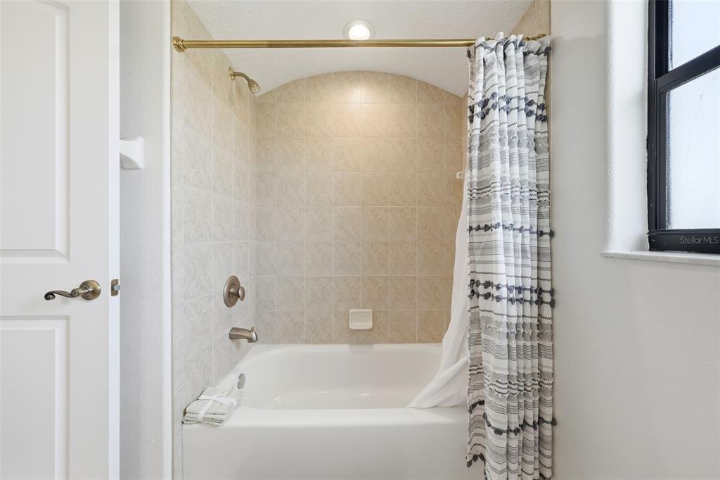 14433 Lake Yale Road Umatilla, FL 32784 - Photo 20 of 38 a bathroom with a shower curtain and a shower curtain