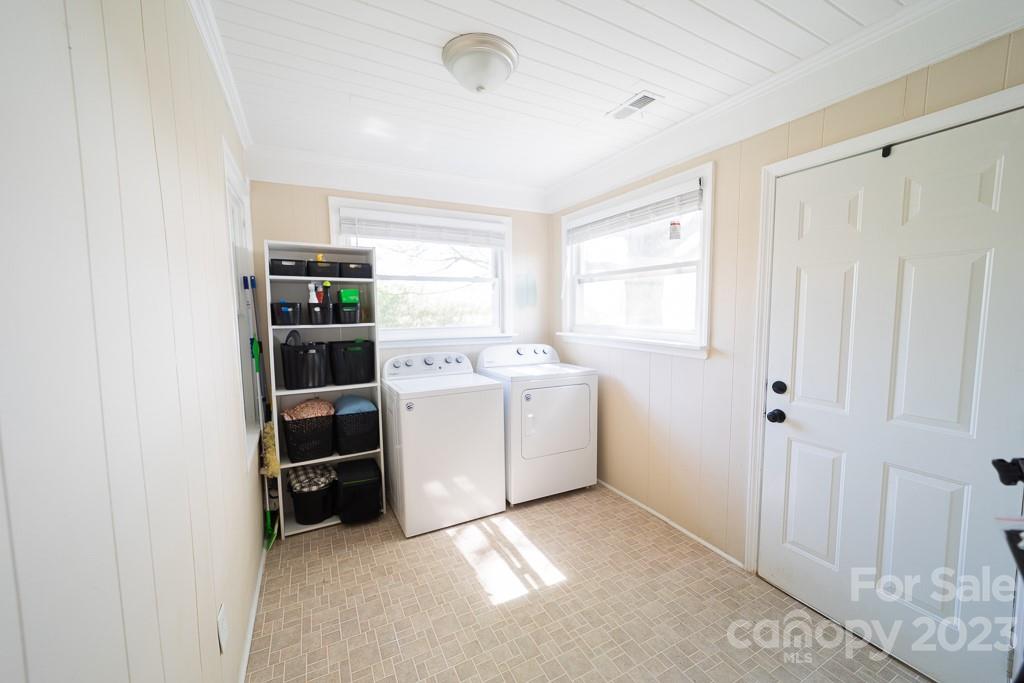 5204 Fish Road Marshville, NC 28103 - Photo 11 of 20 a utility room with cabinets dryer and washer
