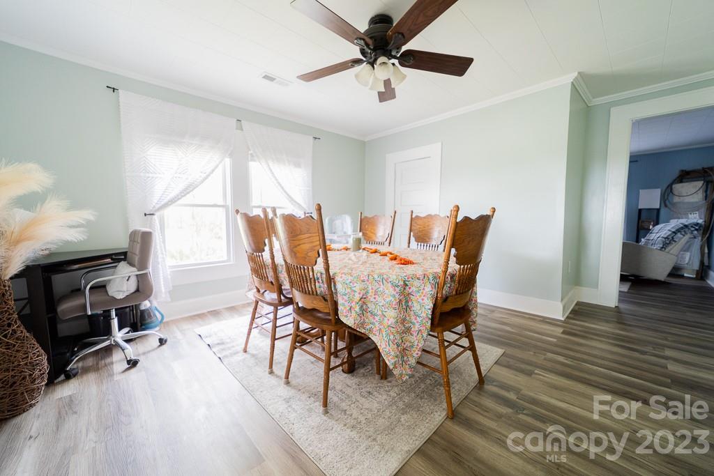 5204 Fish Road Marshville, NC 28103 - Photo 13 of 20 a view of a dining room with furniture and wooden floor