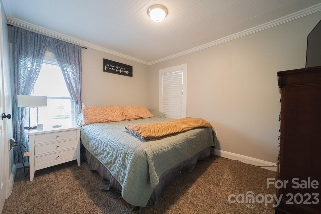 5204 Fish Road Marshville, NC 28103 - Photo 20 of 20 a bedroom with a bed and a cabinets