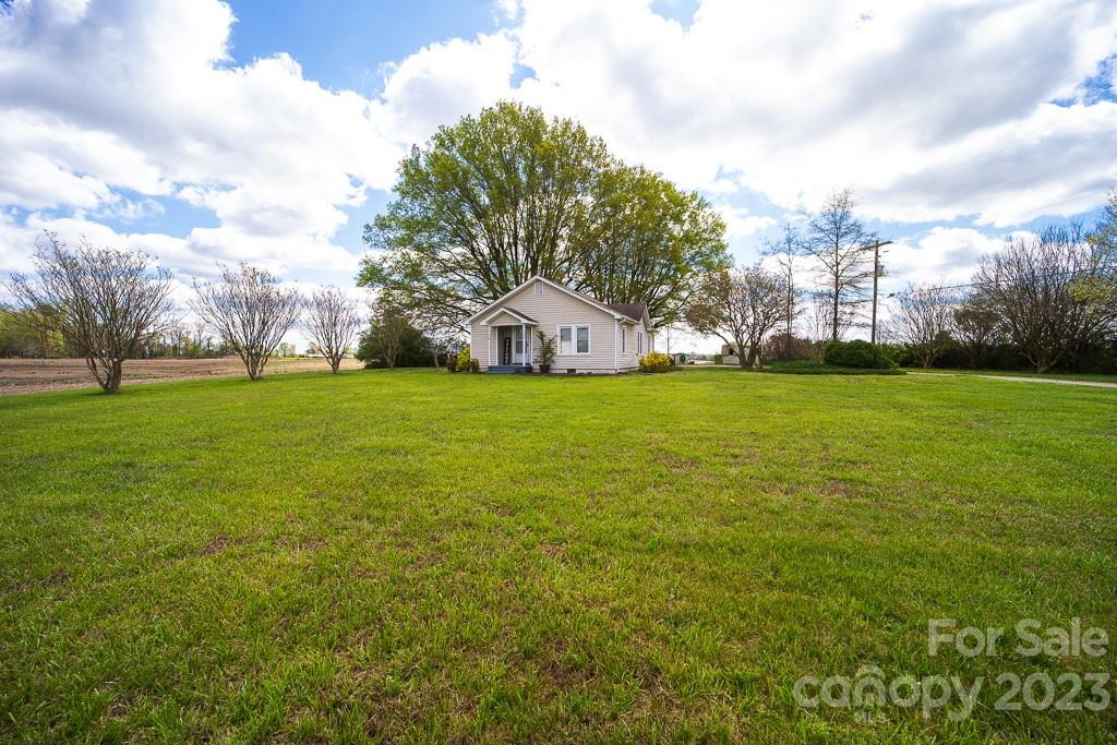 5204 Fish Road Marshville, NC 28103 - Photo 7 of 20 a large building with a big yard and large trees
