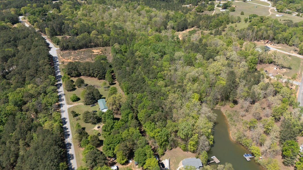0 Bulldog Road Iva, SC 29655 - Photo 13 of 20 An aerial perspective showcases a sprawling landscape of lush greenery bordered by a quiet watercourse.