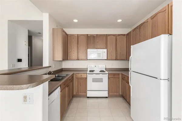 a kitchen with a stove a refrigerator and a sink