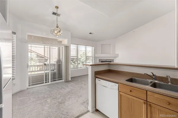 a kitchen with a sink refrigerator and window