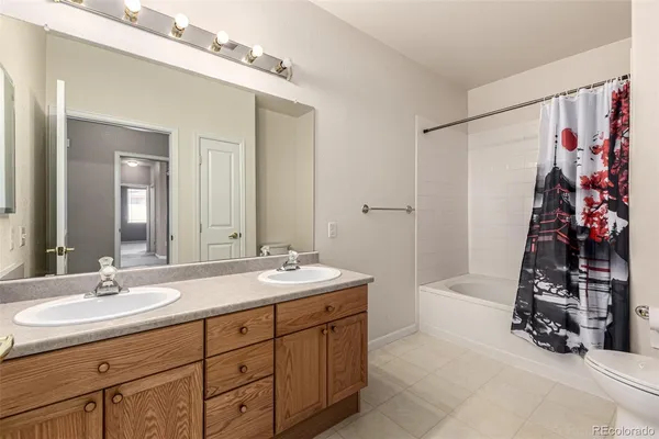 a bathroom with a double vanity sink and mirror