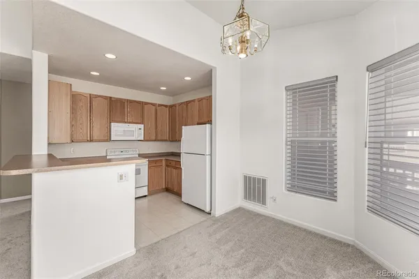 a kitchen with a refrigerator and a sink