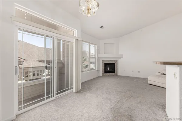 a view of a livingroom with an empty space and a fireplace