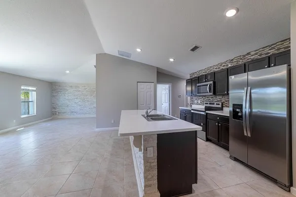 a kitchen with a refrigerator and a sink