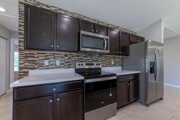 a kitchen with a sink stove and microwave