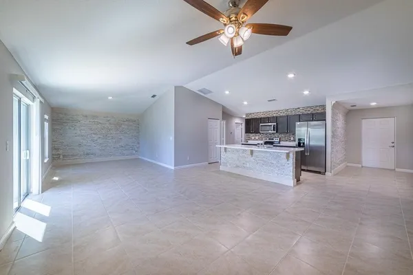 a view of a kitchen with a sink and a refrigerator