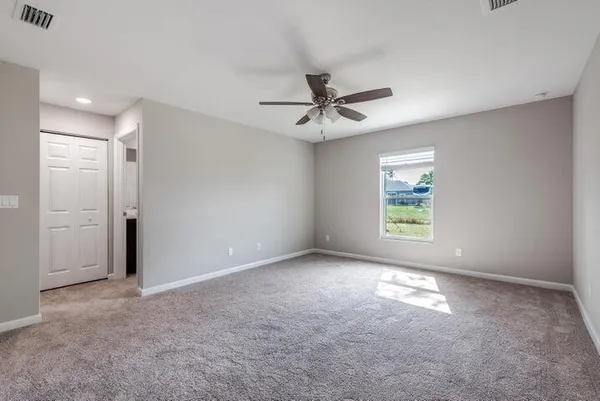 a bedroom with a large bed and a flat screen tv