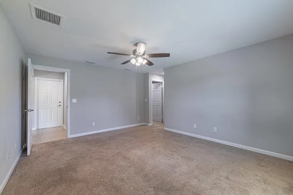 a bedroom with a bed a couch and dresser