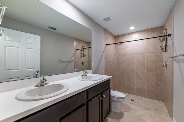 an entryway with a livingroom and a bathroom