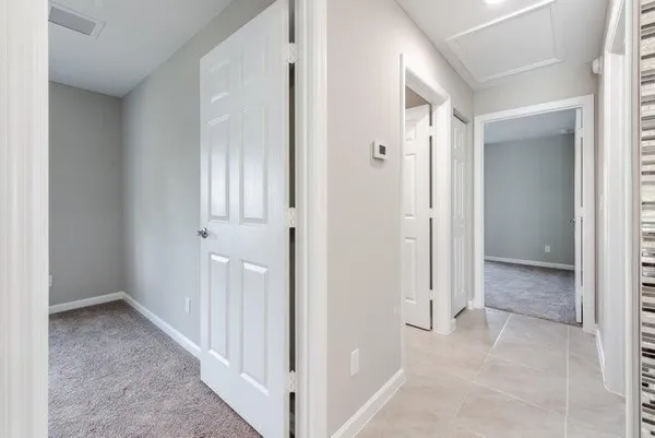 an empty room with closet and a chandelier fan
