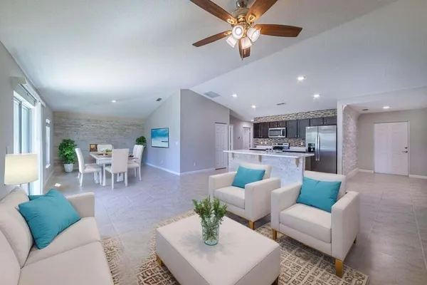 a living room with furniture and kitchen view