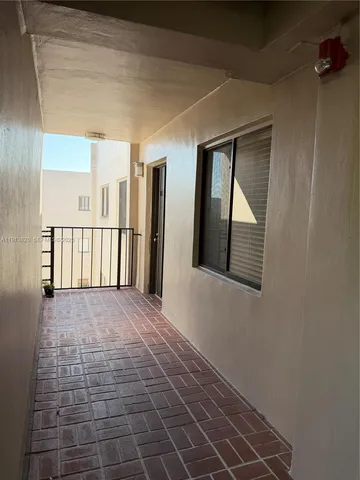 a view of an empty room with windows