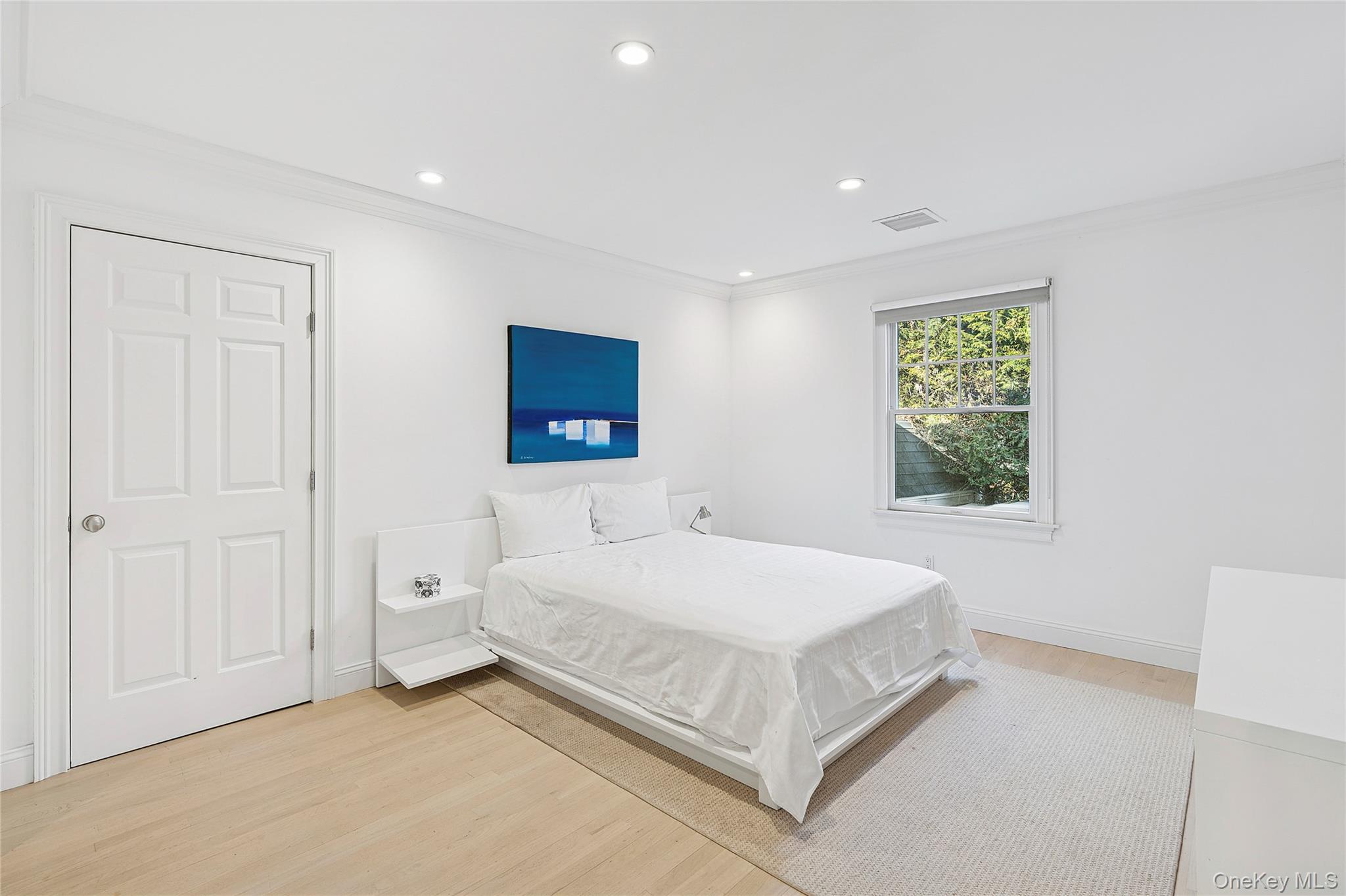 122 Beach Road Westhampton Beach, NY 11978 - Photo 11 of 18 a bedroom with a bed and a window