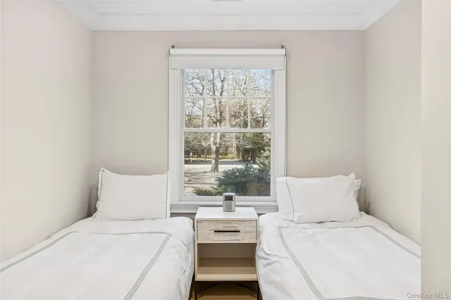 a bedroom with a bed and a window with outer view