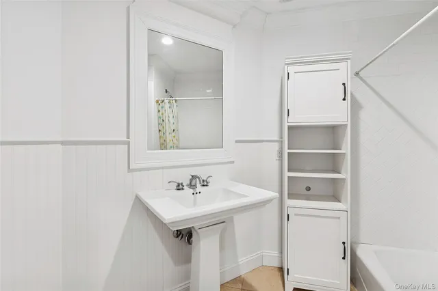 a bathroom with a sink toilet and tub