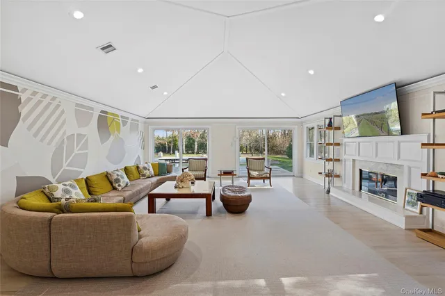 a living room with fireplace furniture and a large window