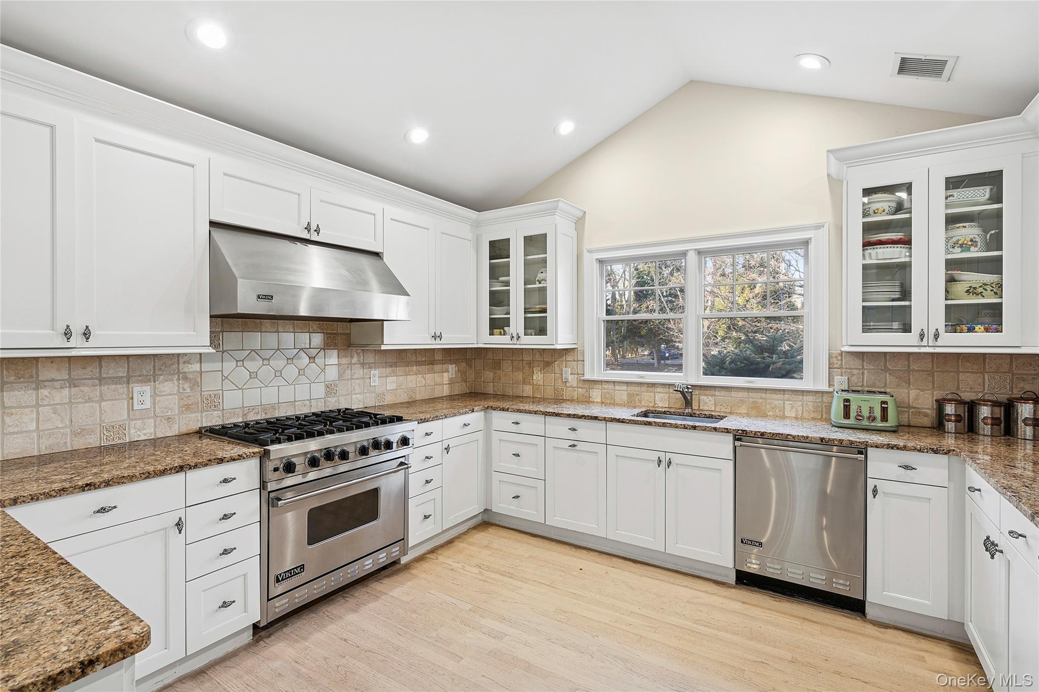 122 Beach Road Westhampton Beach, NY 11978 - Photo 6 of 18 a kitchen with stainless steel appliances granite countertop a stove and a sink