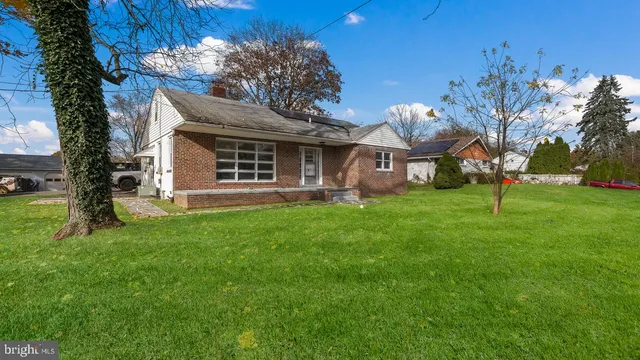 a view of a house with a yard porch and sitting area