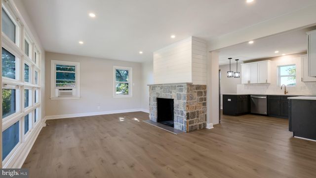 a view of kitchen with sink and fireplace