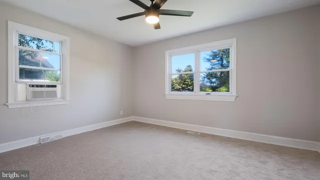 a view of room with window and ceiling fan