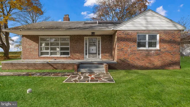 a view of a house with a yard porch and sitting area
