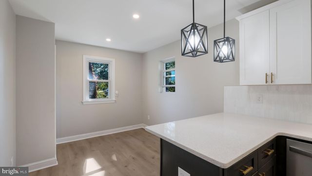 a view of kitchen with cabinets and wooden floor