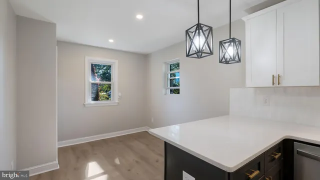 a view of kitchen with cabinets and wooden floor